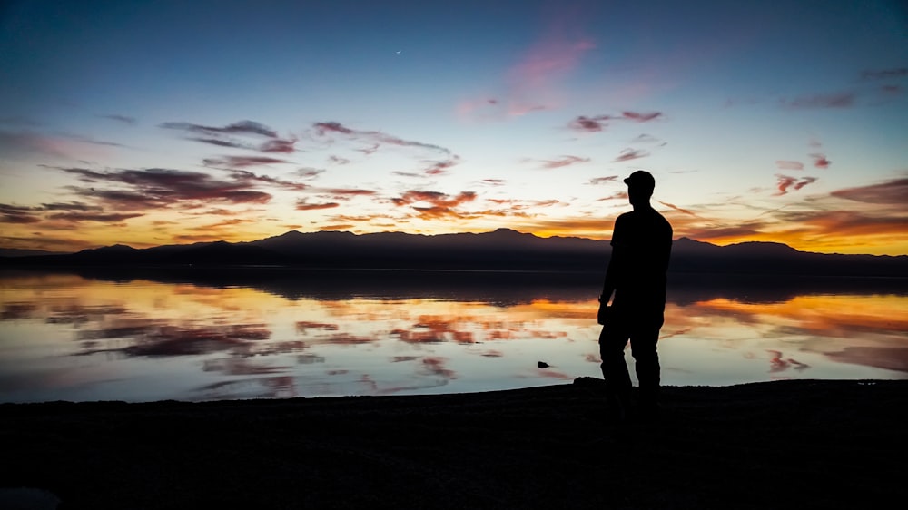 silhouette of man standing on sand