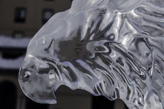A detailed ice sculpture of a logo displayed at an elegant event.