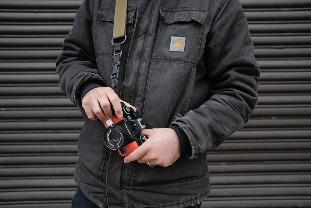 person holding black DSLR camera