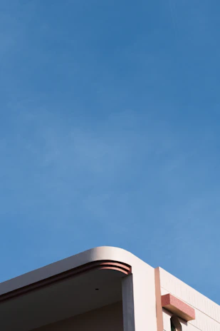 Minimalist architectural detail of a pastel-toned residential facade under soft natural light