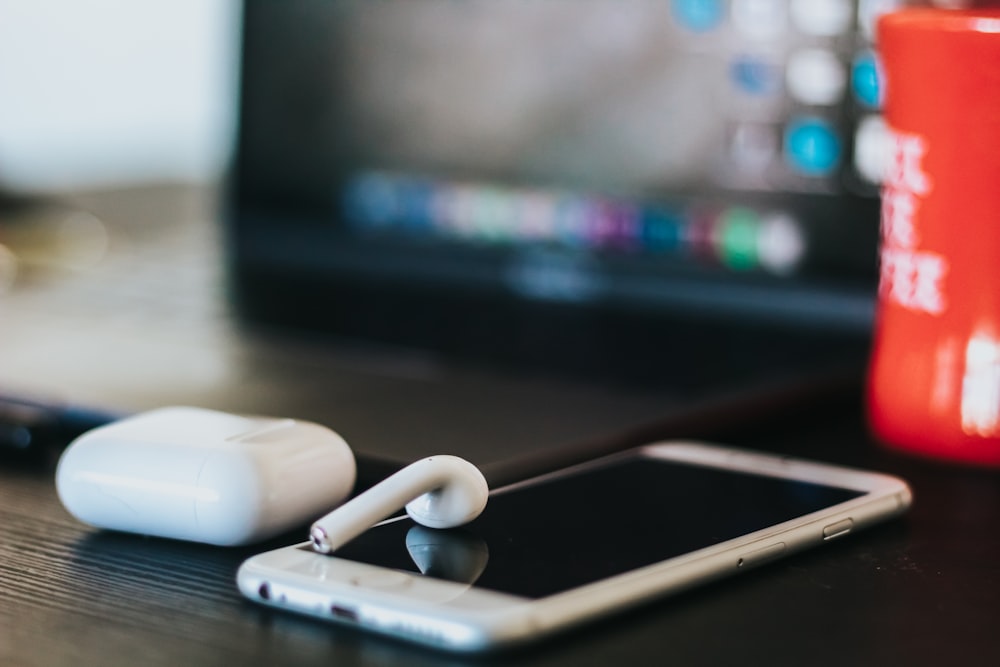 iPhone, AirPods on table