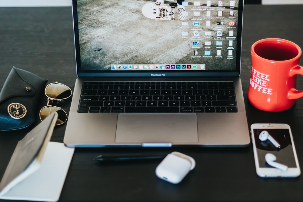 MacBook Pro turned on on black wooden table