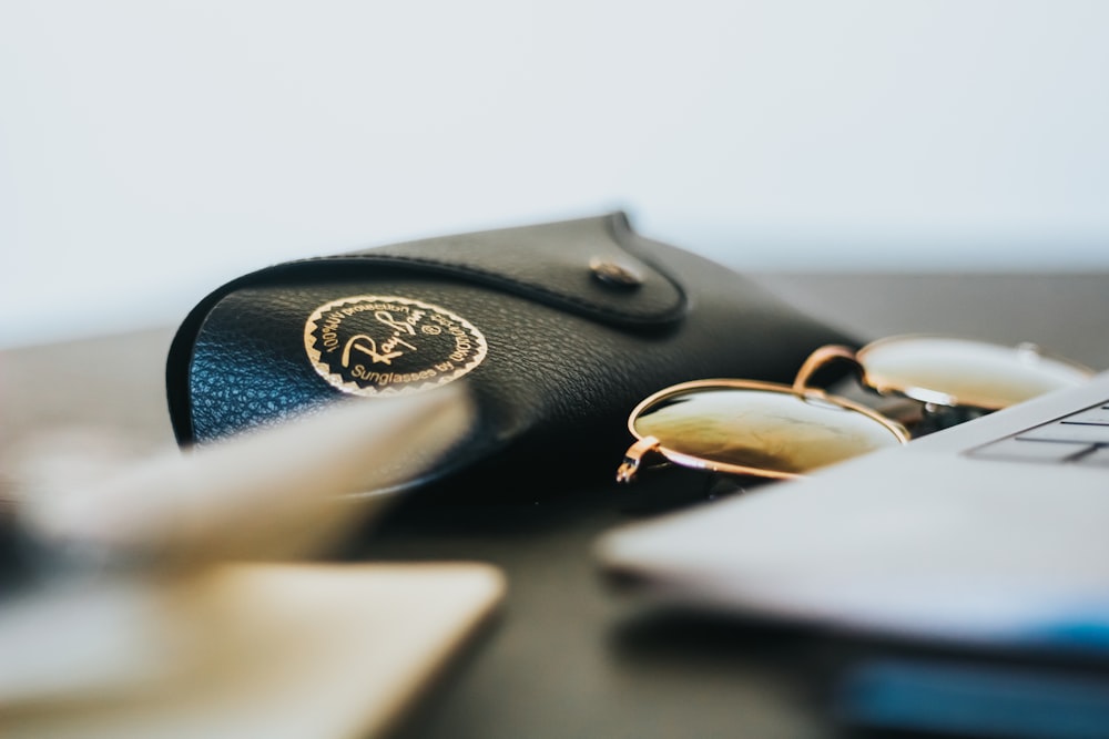 black Ray-Ban sunglasses with leather case