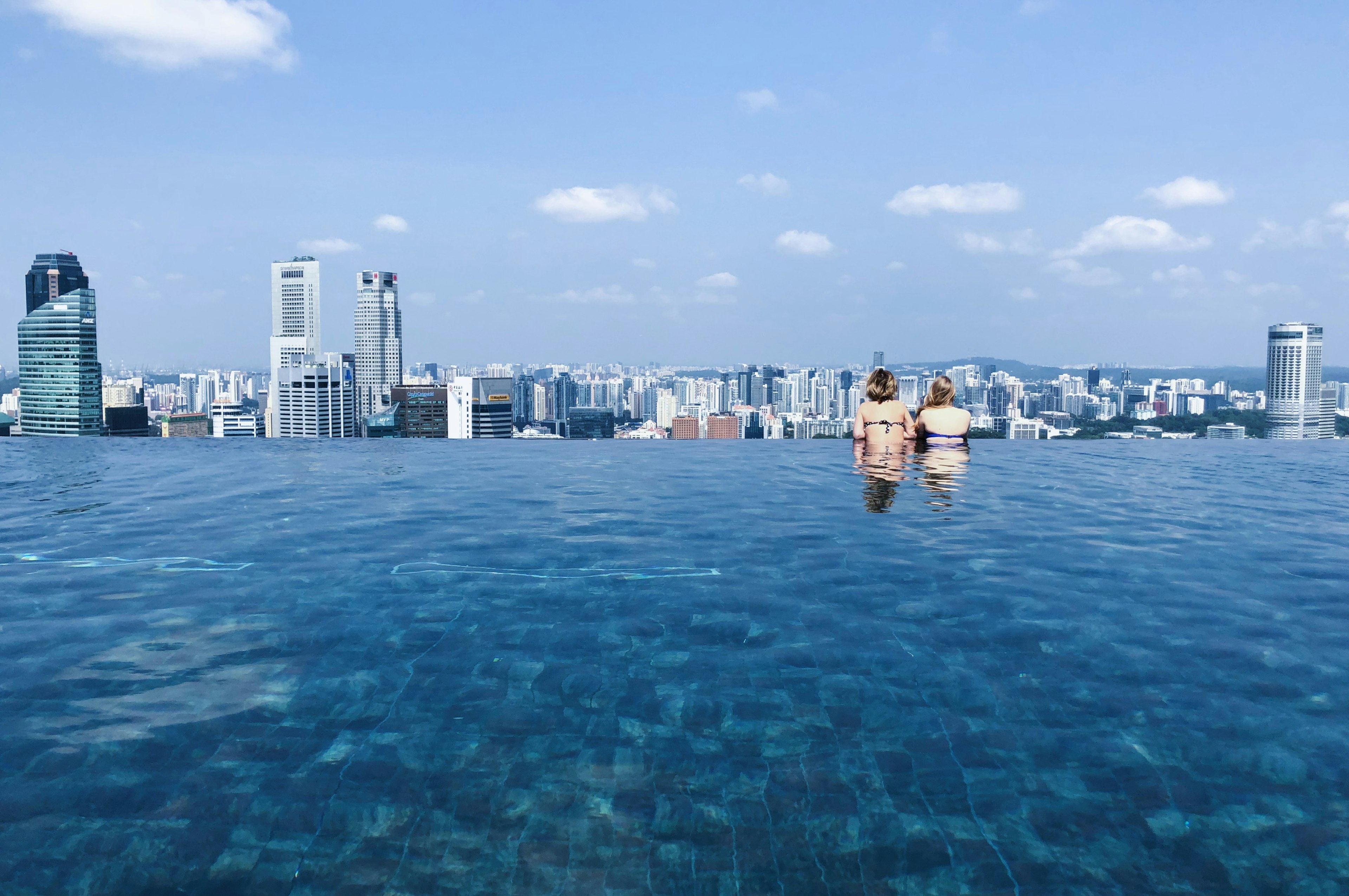 Infinity pool overlooking Marina Bay at sunset