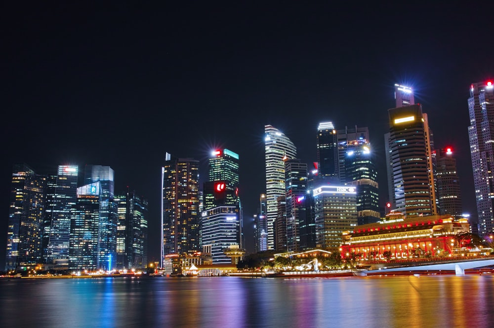 city buildings near bodies of water at night time