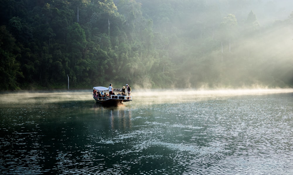 people on black boat during daytime