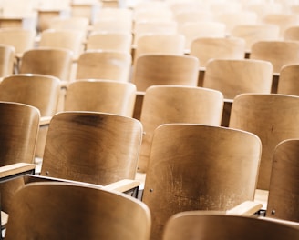 vacant brown wooden chair at stadium