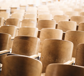 vacant brown wooden chair at stadium