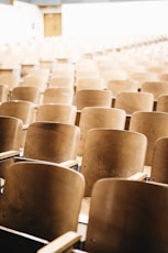 vacant brown wooden chair at stadium