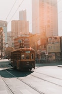 brown cable train near building during daytime