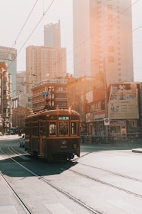 brown cable train near building during daytime