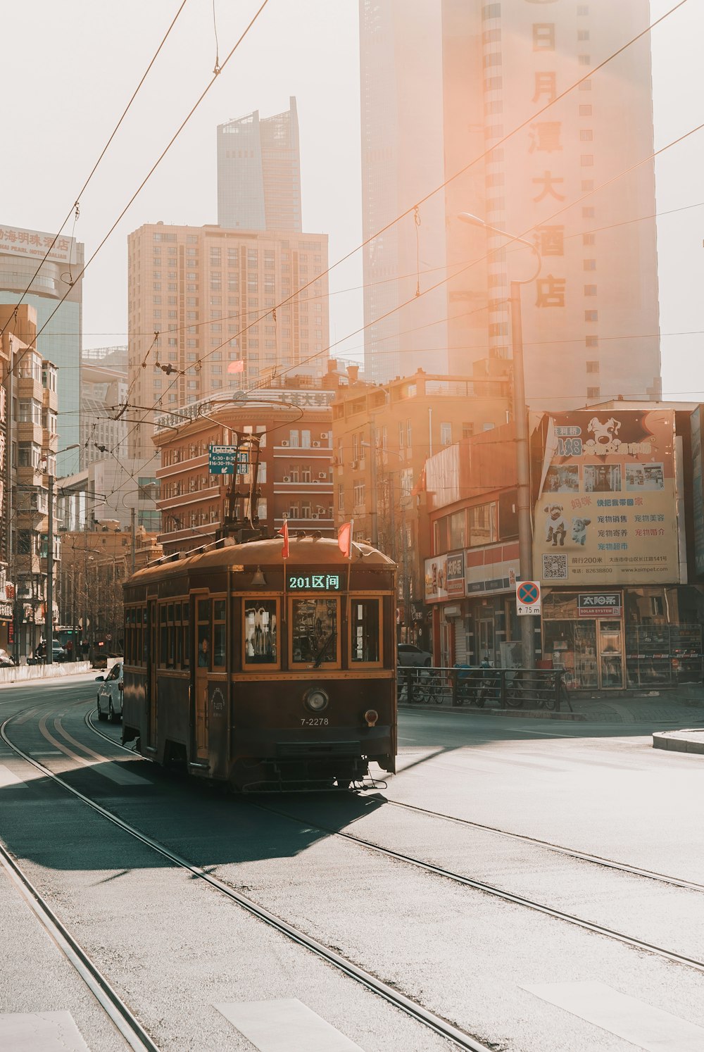 brown cable train near building during daytime