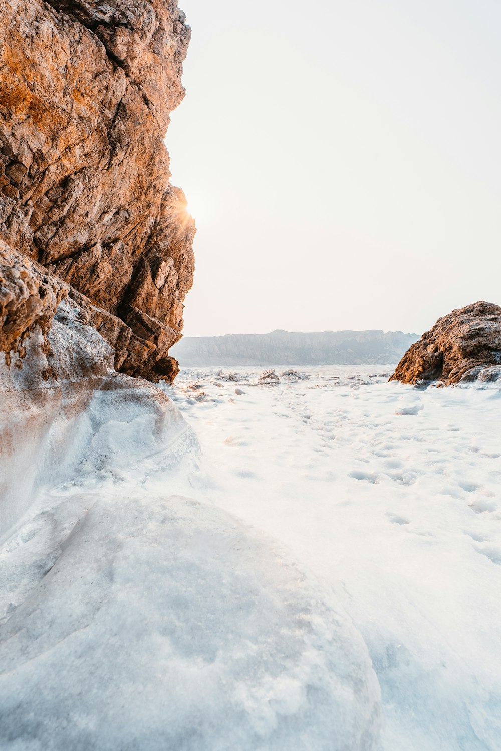 body of water beside rock formation