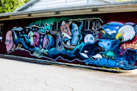 A colorful mural depicting nature and interconnectedness.