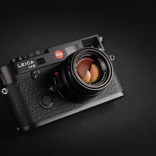 Black Leica M6 film camera photographed in a studio against a dark background