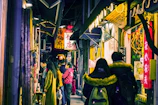 Narrow bustling alleyway filled with colorful shops and locals.