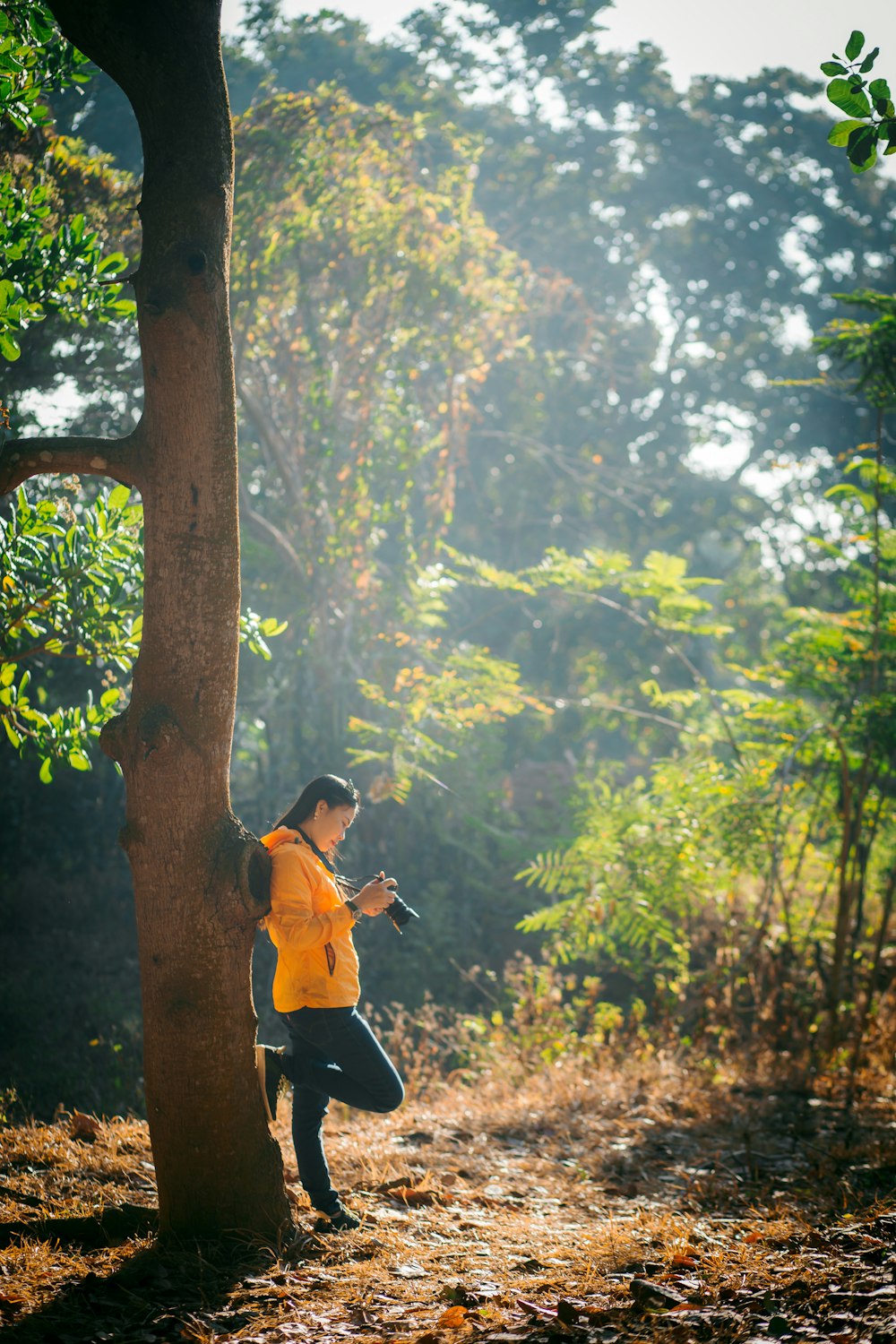 woman standing beside tree at daytimre