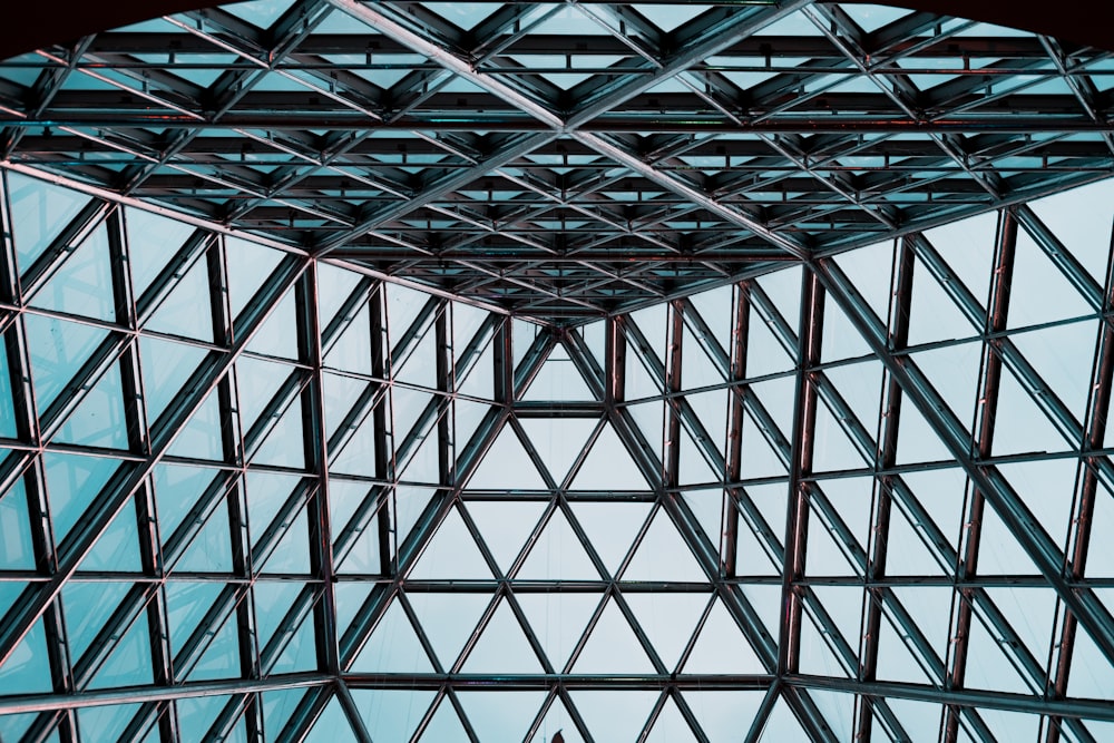 low angle photo of gray clear glass building