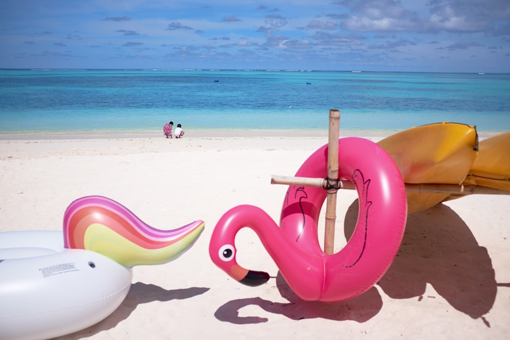 pink flamingo floater in front ocean