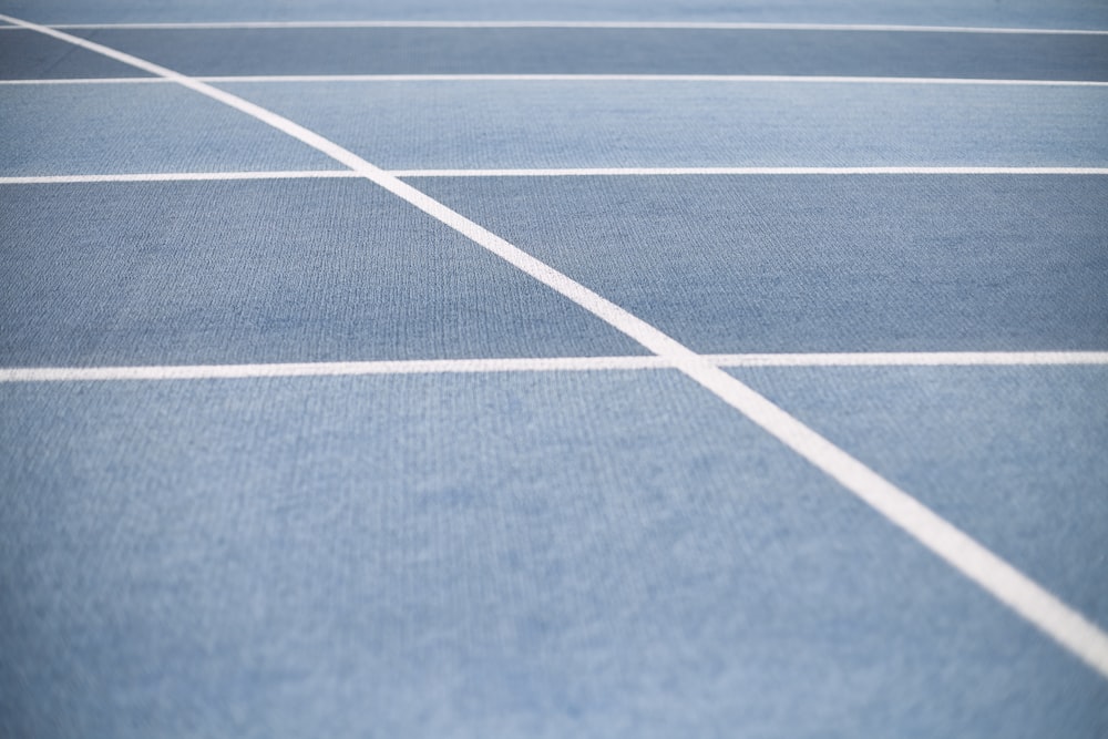 a blue tennis court with white lines on it