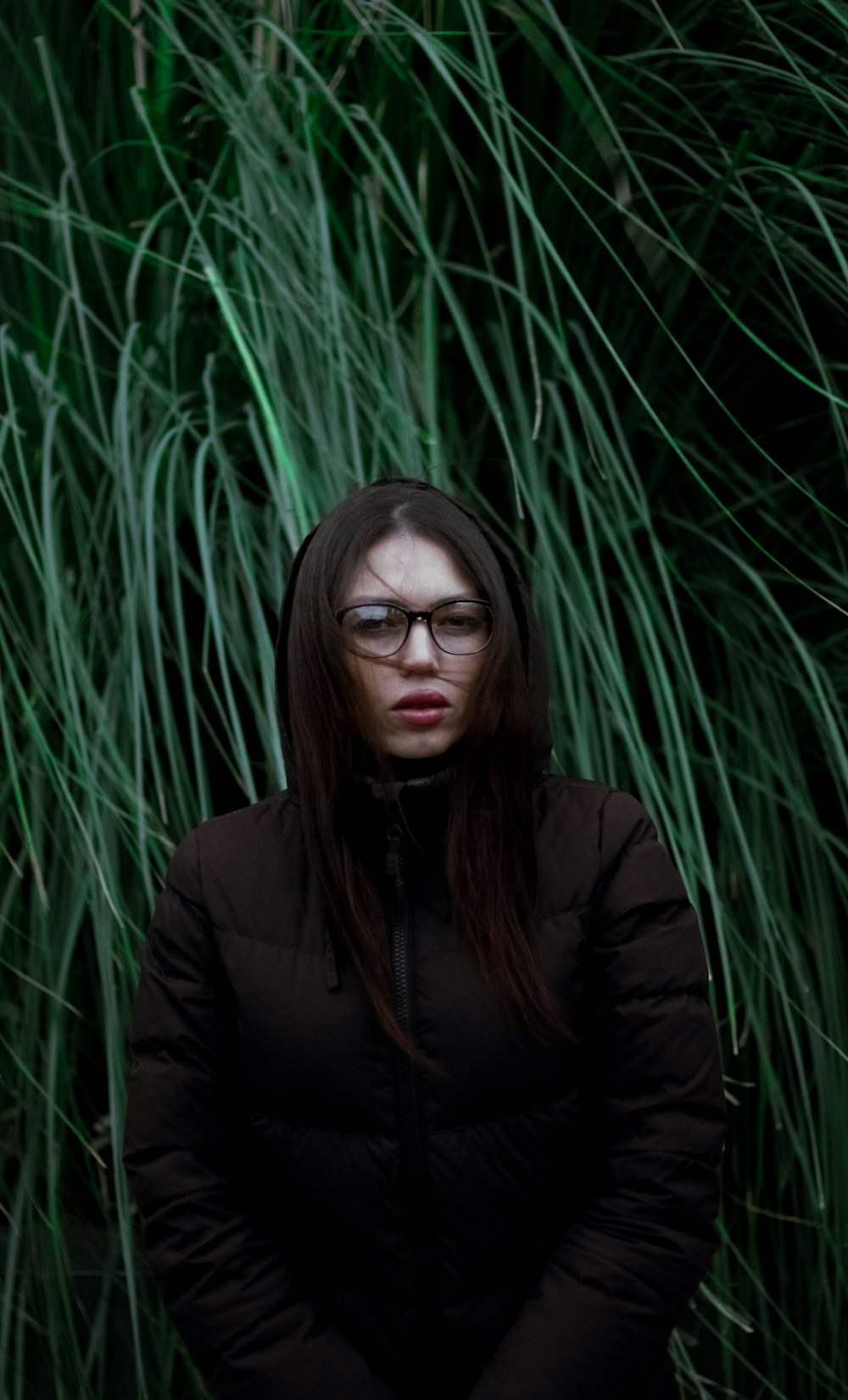 woman standing behind grass