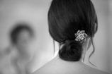 Close-up of an elegant updo featuring intricate braids and pearl pins.