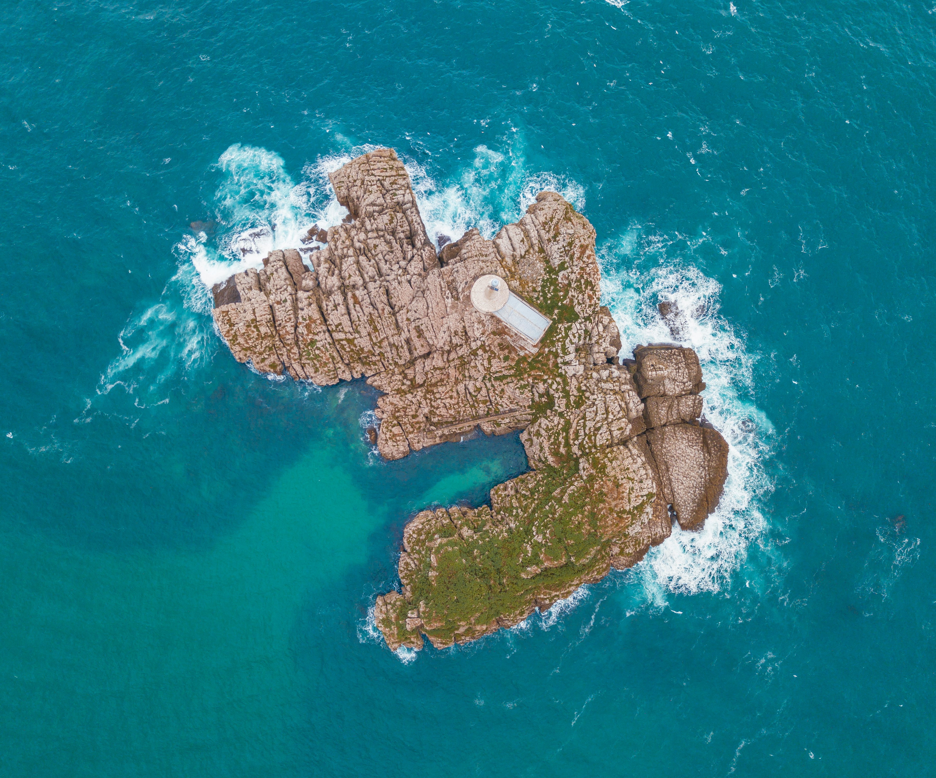 aerial photography of brown island surrounded by body of water at daytime