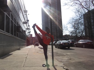 A person peacefully enjoying a quick morning stretch in a busy urban setting.