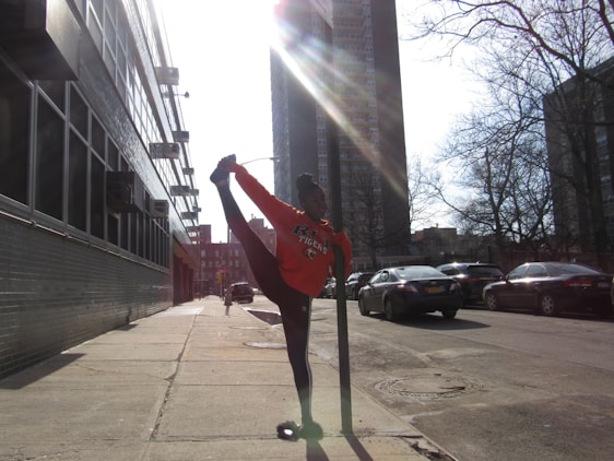 A person peacefully enjoying a quick morning stretch in a busy urban setting.