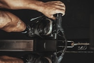 Athlete mid-workout using a state-of-the-art rowing machine with dynamic motion blur.