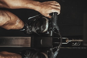 Customer using a rowing machine with a focused expression.