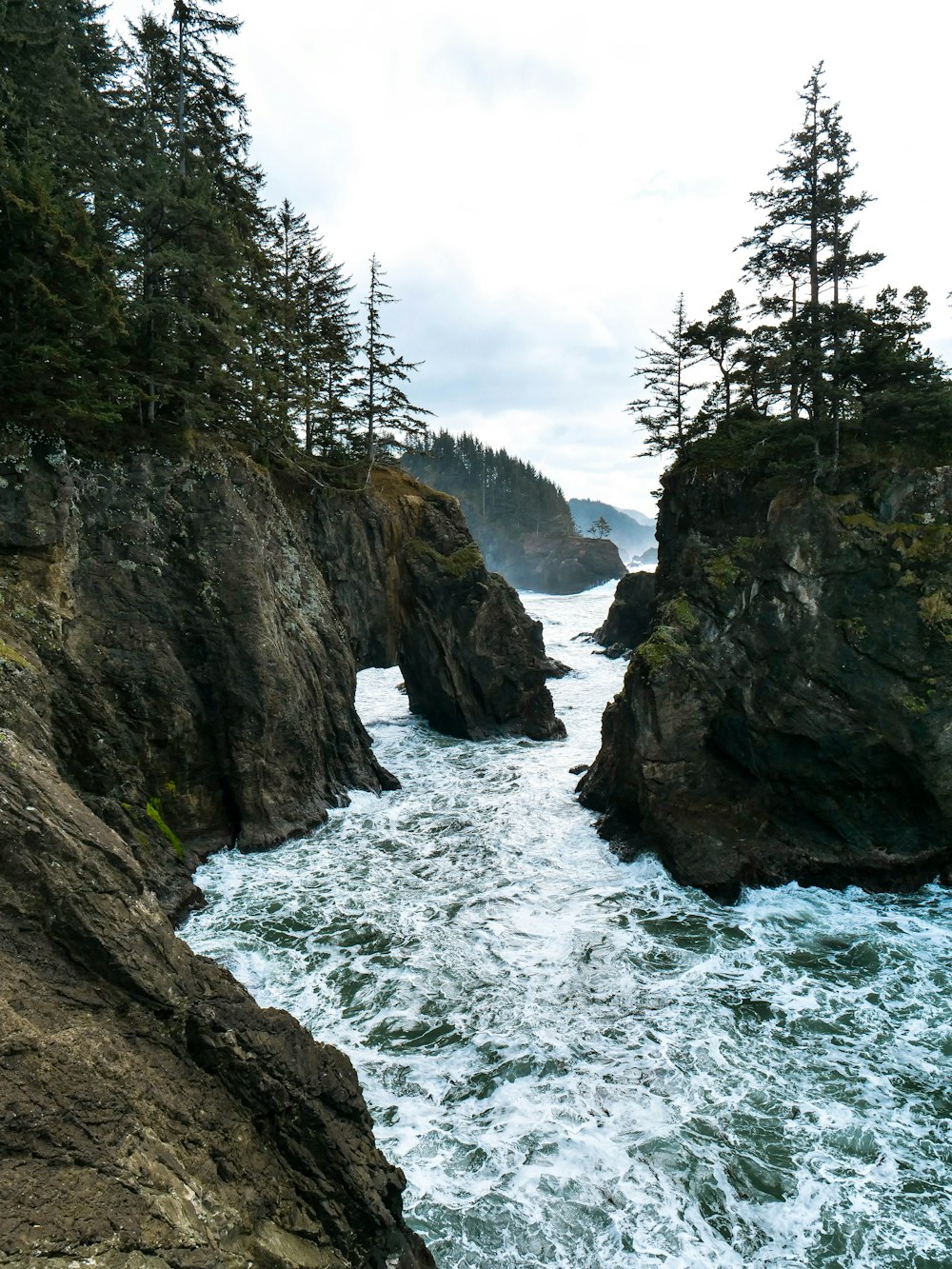 landscape photography of outcrop near body of water