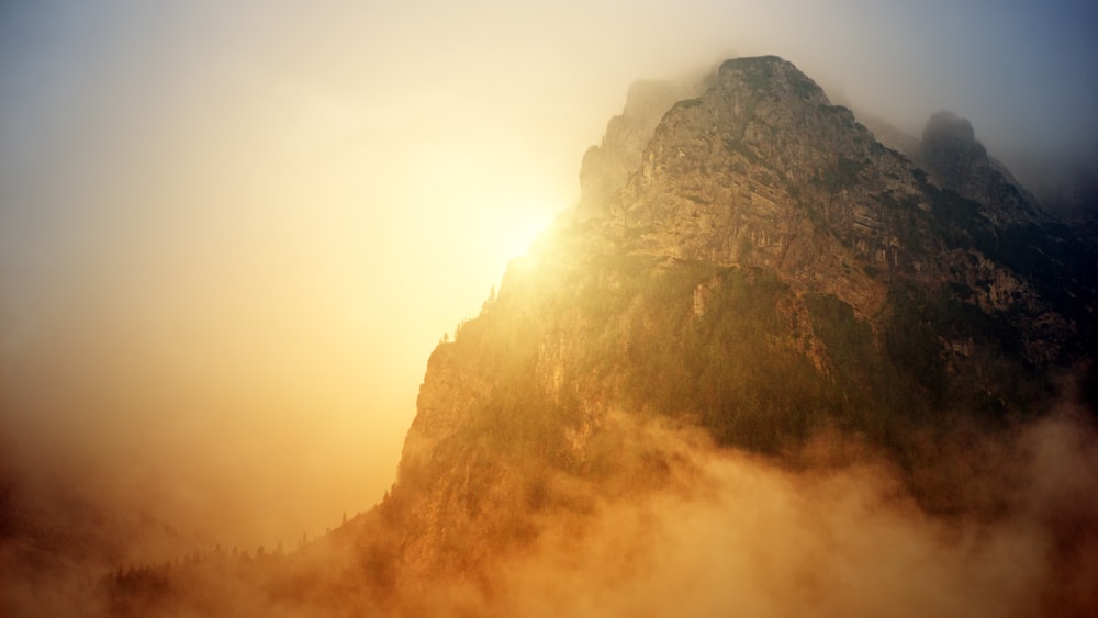 gray rocky mountain with trees during golden hour photo