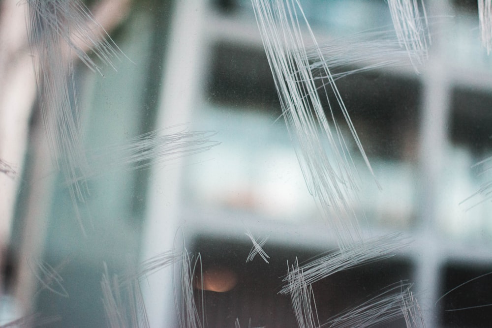 a close up of a window with a building in the background