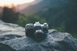 Close-up of a vintage film camera set against a backdrop of Appalachian mountains.