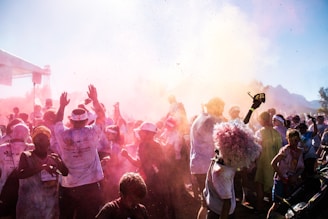 Vibrant runners covered in colorful powder mid-race during the djoeang color run