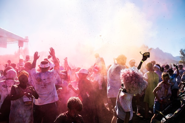 Vibrant runners covered in colorful powder mid-race during the djoeang color run