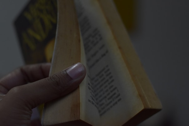 A close-up of Andy’s hands holding a well-worn copy of his authored book.
