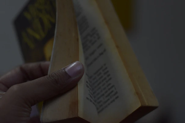 Close-up of hands flipping through a colorful health and wellness book.