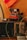 A vintage setup featuring a retro Polaroid camera, an old-fashioned radio with a tuning dial, and a reserved sign. A bicycle wheel and a crocheted orange fabric are partially visible, adding to the nostalgic ambiance.