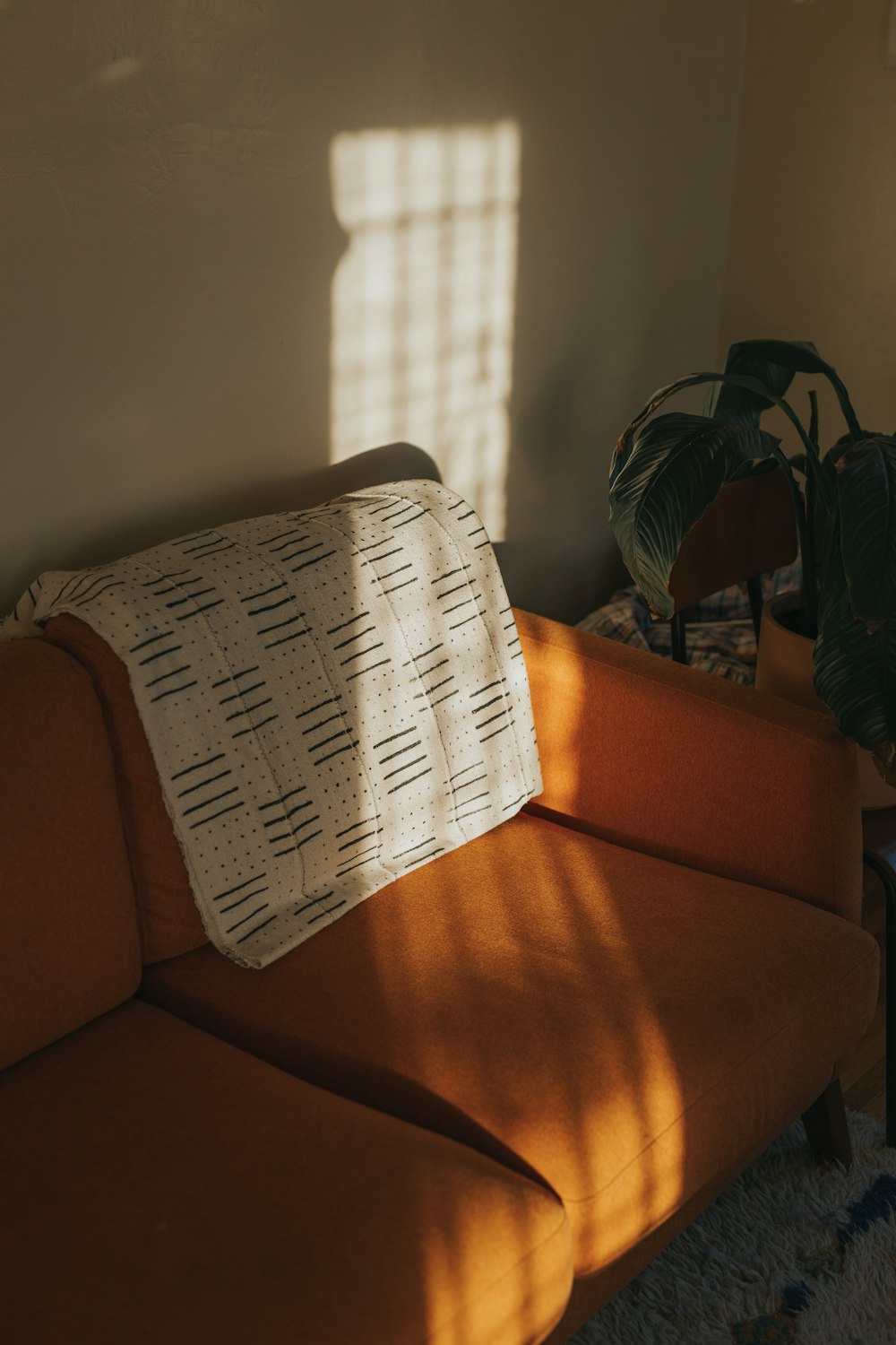 white textile on brown couch