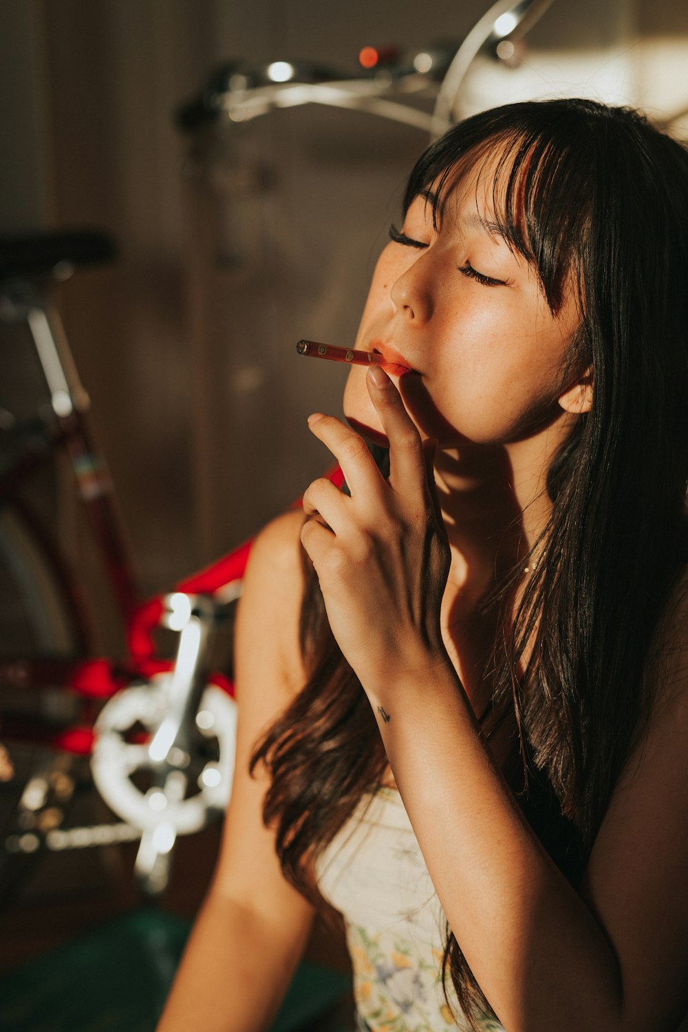 woman smoking cigarette while closing her eyes