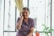 A joyful woman smiling while on a video call.