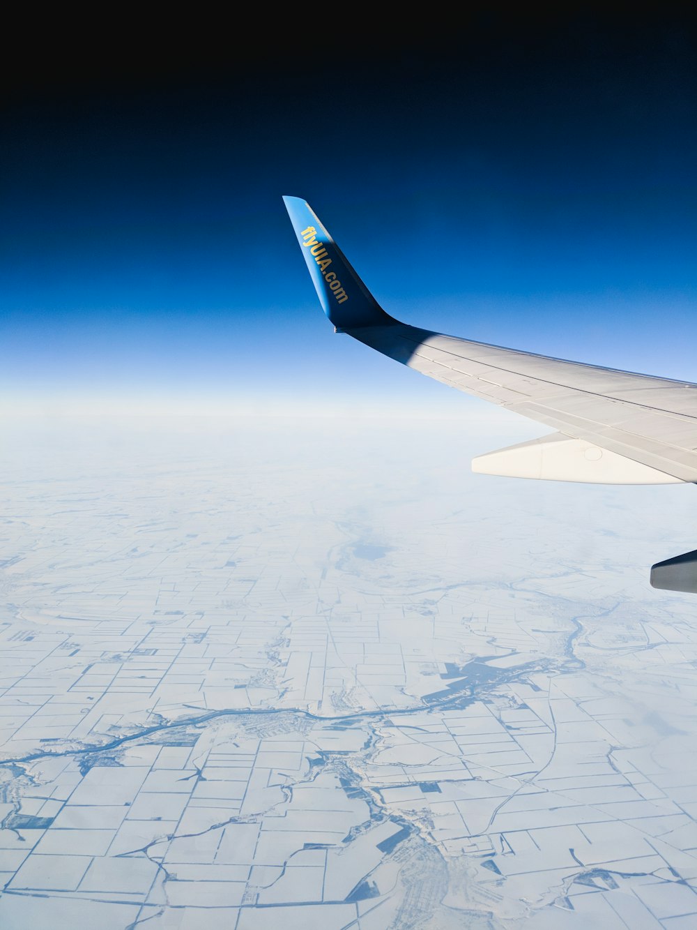 aerial photography of white and blue airplane