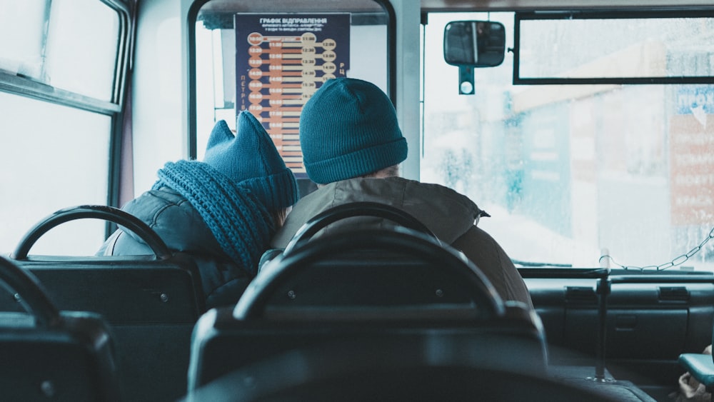 two people sitting inside buss