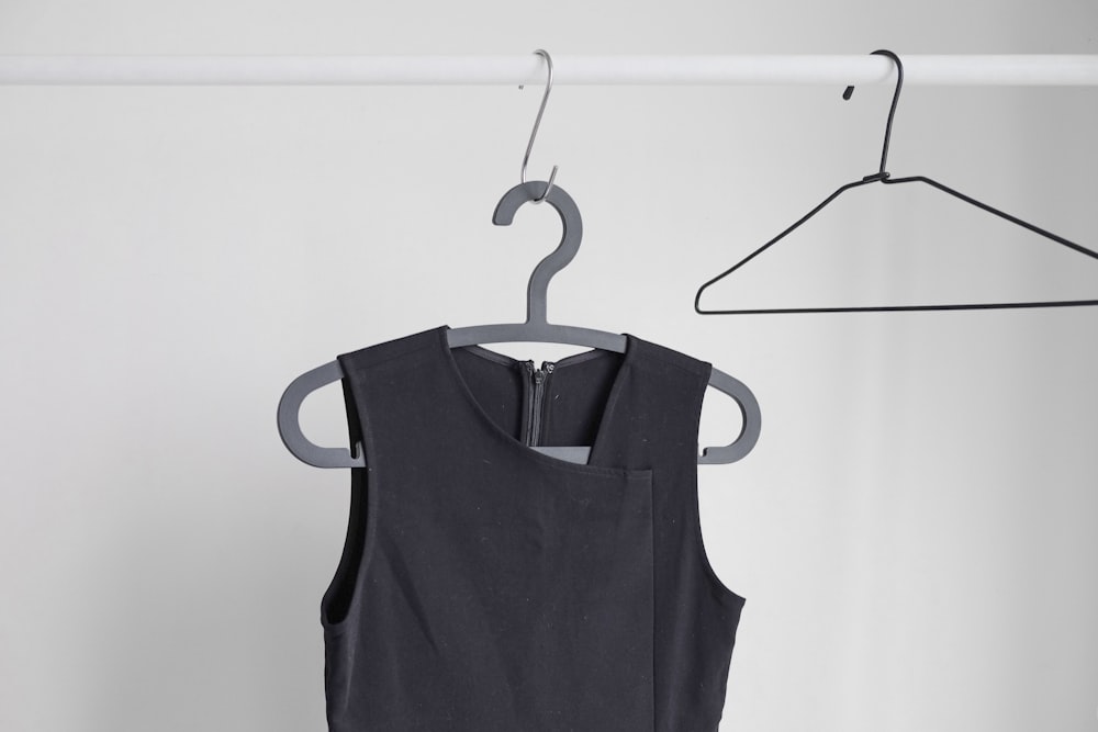black sleeveless top hanging on wardrobe