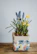 Close-up of the pastel decorative flower pot sitting on the biršvė console table.