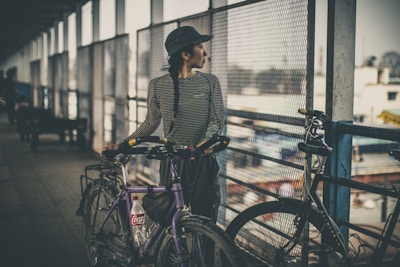woman holding purple city bicycle