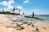group of people climbing on stand beside seashore
