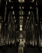 Softly lit temple interior with glowing sacred lamps and rich floral decorations.